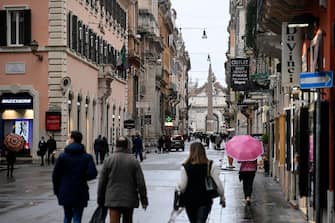 Few people for the city due to the rain in via del Corso in Rome, Italy, February 7, 2021. There were no criticalities due to the gatherings due to bad weather. ANSA/RICCARDO ANTIMIANI