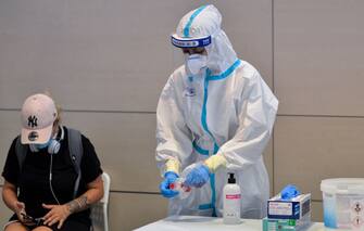 TURIN, ITALY - AUGUST 19: The personnel assigned for testing of Covid-19 at the testing site at Turin airport on August 19, 2020 in Turin, Italy. The Italian government is requiring people arriving from high-risk designated countries to take a Covid-19 test, which includes regions in Spain, Greece, Croatia and Malta. According to the Ministry of Health, Coronavirus infection rates are climbing again in Italy from an average of 400 new cases per day. Authorities see Italian returning from vacation abroad as a likely strong contributor to the uptick in infections. (Photo by Diego Puletto/Getty Images)