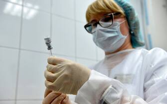 A nurse prepares to inoculate volunteer Ilya Dubrovin, 36, with Russia's new coronavirus vaccine in a post-registration trials at a clinic in Moscow on September 10, 2020. - Russia announced last month that its vaccine, named "Sputnik V" after the Soviet-era satellite that was the first launched into space in 1957, had already received approval. The vaccine was developed by the Gamaleya research institute in Moscow in coordination with the Russian defence ministry. (Photo by Natalia KOLESNIKOVA / AFP) (Photo by NATALIA KOLESNIKOVA/AFP via Getty Images)