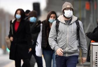Commuters walk past Melbourne's Flinders Street Station on July 23, 2020 on the first day of the mandatory wearing of face masks in public areas as the city experiences an outbreak of the COVID-19 coronavirus. (Photo by William WEST / AFP) (Photo by WILLIAM WEST/AFP via Getty Images)