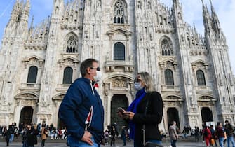 Man and woman stroll through the city with protective masks and sanitizing gels to counteract the possible infection of the ''CoronaVirus'',Milan,Italy, February 23,2020 (Photo by Andrea Diodato/NurPhoto via Getty Images)