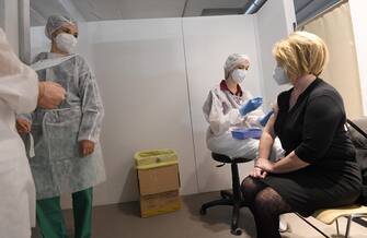 A school teacher receives the anti-Covid AstraZeneca vaccine from a health care personnel at the covid vaccination center set up at the Museums of Science and Technology, Milan, Italy, 8 March 2021.ANSA/DANIEL DAL ZENNARO 