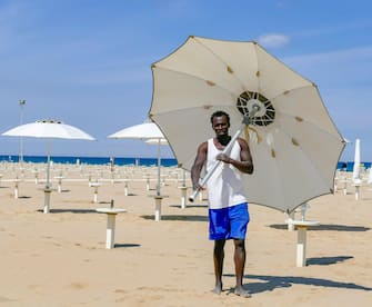 Beach staff prepares poles for the installation of parasols at "Bagno 62" on the Adriatic  coast on the first day of the bathing season in Rimini, Italy, 15 May 2021. Italy is significantly easing its COVID-19-linked restrictions.
ANSA/PASQUALE BOVE