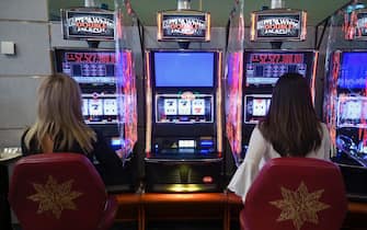 epa08458411 Women play at a video slot machine next to ones that are placed out of service at the recently reopened Casino du Liban amid the spread of coronavirus in Jounieh northern Beirut, Lebanon, 01 June 2020. Casino du Liban opened on 01 June 2020 to the public for the first time after two and a half months of lockdown, as more establishments were allowed to reopen and curfew hours were drastically reduced with COVID-19 cases remaining relatively stable.  EPA/WAEL HAMZEH