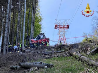 A handout photo made available by Italian Fire and Rescue Service shows Rescuers at work at the area of the cable car accident, near Lake Maggiore, northern Italy, 23 May 2021. The cable car that connects Stresa with Mottarone has crashed, claiming 14 lives, according to the latest toll. The accident has been caused by the failure of a rope, in the highest part of the route which, starting from Lake Maggiore reaches an altitude of 1,491 meters.  ANSA/ITALIAN FIRE AND RESCUE SERVICE / HANDOUT  HANDOUT EDITORIAL USE ONLY/NO SALES