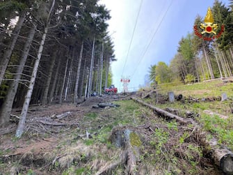 A handout photo made available by Italian Fire and Rescue Service shows Rescuers at work at the area of the cable car accident, near Lake Maggiore, northern Italy, 23 May 2021. The cable car that connects Stresa with Mottarone has crashed, claiming 14 lives, according to the latest toll. The accident has been caused by the failure of a rope, in the highest part of the route which, starting from Lake Maggiore reaches an altitude of 1,491 meters.  ANSA/ITALIAN FIRE AND RESCUE SERVICE / HANDOUT  HANDOUT EDITORIAL USE ONLY/NO SALES