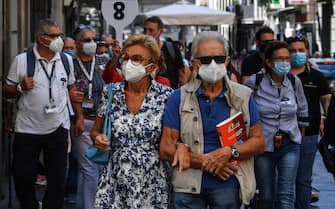 Tourists wear face masks after the southern Italian region of Campania made it mandatory to wear protective face coverings outdoors 24 hours a day, to contain the coronavirus disease (COVID-19) outbreak
