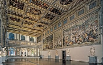 Italy, Tuscany, Florence, Palazzo Vecchio. Whole artwork view. View of the room with coffered ceiling and walls with battle scenes dedicated to the exaltation of Cosimo I de 'Medici.