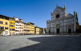 A photo taken on February 23, 2021 on Piazza Santa Croce in Florence shows a 1865 sculpture of Italian poet, writer and philosopher Dante Alighieri (Rear C-R), by Italian sculptor Enrico Pazzi, by the Basilica di Santa Croce. - Florence celebrates in 2021 the 700th anniversary of the death of Dante Alighieri, who helped establish with works such as "The Divine Comedy" the modern-day standardized Italian language, and set a precedent that important later Italian writers such as Petrarch and Boccaccio would follow. (Photo by Vincenzo PINTO / AFP) (Photo by VINCENZO PINTO/AFP via Getty Images)