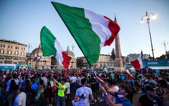 Tifosi azzurri sventolano bandiere dell'Italia in piazza del Popolo, a Roma, durante una partita di Euro 2020