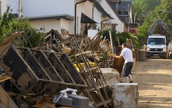 19 July 2021, Rhineland-Palatinate, Sinzig: Bulky waste piles up in the streets of Sinzig. The storm destroyed the furniture in numerous households.A bent signpost points to the Lebenshilfe house in Sinzig. Twelve people had lost their lives in the facility for the disabled as a result of the flood. Photo: Thomas Frey/dpa (Photo by Thomas Frey/picture alliance via Getty Images)