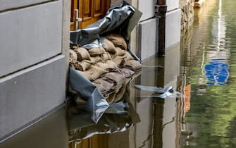 19 July 2021, Bavaria, Passau: Sandbags protect the entrance to a house on the Danube. The situation in the flooded areas in the south and east of Bavaria has eased somewhat. Photo: Armin Weigel/dpa (Photo by Armin Weigel/picture alliance via Getty Images)