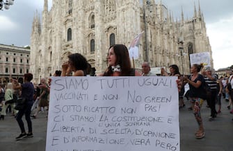 Demonstrators during a protest against the  Green Pass  vaccine passport in the centre of Milan, Italy, 07 August 2021. New rules kick in on Friday making it obligatory to have the Green Pass to access cinemas, museums, theaters and swimming pools in Italy, as well as to eat indoors in bars and restaurants. Furthermore, Premier Mario Draghi's cabinet on Thursday approved measures that will further expand the scope of the Green Pass, making it obligatory for long-distance travel on trains, buses, ferries and flights within Italy from September and making it mandatory for school and university staff as well as for college students. The Italian Green Pass certifies that a person is vaccinated for COVID-19, has recovered from the Coronavirus or has tested negative in the last 48 hours. Milan 7 August 2021.ANSA/MATTEO BAZZI