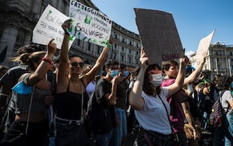 Protesters with signs and slogans during the demonstration Fridays for Future for the global climate strike in Rome, Italy, 24 September 2021. ANSA/ANGELO CARCONI