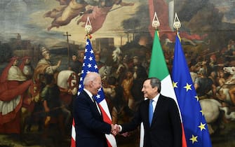 Italy's Prime Minister, Mario Draghi (R) greets US President Joe Biden upon his arrival for their meeting at the Chigi palace in Rome on October 29, 2021, ahead of an upcoming G20 summit of world leaders to discuss climate change, covid-19 and the post-pandemic global recovery. (Photo by Brendan Smialowski / AFP) (Photo by BRENDAN SMIALOWSKI/AFP via Getty Images)