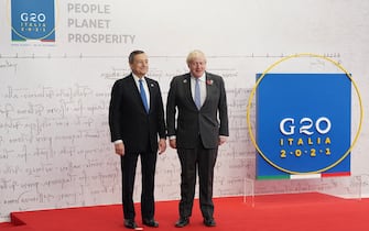 ROME, ITALY - OCTOBER 30: Italian Prime Minister Mario Draghi (L) welcomes British Prime Minister Boris Johnson to the G20 summit on October 30, 2021 in Rome, Italy. The G20 (or Group of Twenty) is an intergovernmental forum comprising 19 countries plus the European Union.  It was founded in 1999 in response to several world economic crises. Italy currently holds the Presidency of the G20 and this year's summit will focus on three broad, interconnected pillars of action: People, Planet, Prosperity.  (Photo by Stefan Rousseau - Pool/Getty Images)