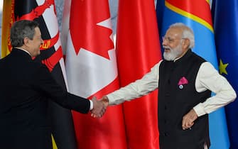 Italy's Prime Minister, Mario Draghi (L) greets Indian Prime Minister Narendra Modi as he arrives for the G20 of World Leaders Summit on October 30, 2021 at the convention center "La Nuvola" in the EUR district of Rome. (Photo by Alberto PIZZOLI / AFP) (Photo by ALBERTO PIZZOLI/AFP via Getty Images)