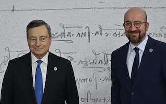 Italy's Prime Minister, Mario Draghi (L) greets President of the European Council Charles Michel as he arrives for the G20 of World Leaders Summit on October 30, 2021 at the convention center "La Nuvola" in the EUR district of Rome. (Photo by Alberto PIZZOLI / AFP) (Photo by ALBERTO PIZZOLI/AFP via Getty Images)