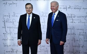 Italy's Prime Minister, Mario Draghi (L) greets US President Joe Biden as he arrives for the G20 of World Leaders Summit on October 30, 2021 at the convention center "La Nuvola" in the EUR district of Rome. (Photo by Brendan Smialowski / POOL / AFP) (Photo by BRENDAN SMIALOWSKI/POOL/AFP via Getty Images)