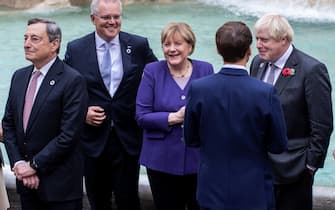 31 October 2021, Italy, Rome: (L-R) Italian Prime Minister Mario Draghi, Australian Prime Minister Scott Morrison, German Chancellor Angela Merkel, French President Emmanuel Macron, and UK Prime Minister Boris Johnson visit the Trevi fountain on the sidelines of the G20 of World Leaders Summit. Photo: Oliver Weiken/dpa (Photo by Oliver Weiken/picture alliance via Getty Images)