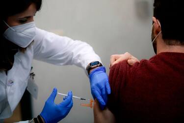 A health care worker receives the Pfizer-BioNTech COVID-19 vaccine at the Tor Vergata  hospital in Rome on December 28, 2020. - Italy will receive 470.000 doses of vaccines against Covid-19 per week, starting from the 28th of December. Most EU countries launch their vaccination campaigns in a bid to defeat Covid-19, as the growing spread of a new coronavirus variant intensifies fears the pandemic could wreak further devastation. (Photo by Filippo MONTEFORTE / AFP) (Photo by FILIPPO MONTEFORTE/AFP via Getty Images)