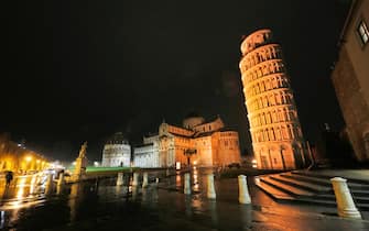The leaning tower of Pisa lit in orange for the United Nations International Day for the Elimination of Violence Against Women, in Pisa, Italy, 25 November 2021.ANSA / FABIO MUZZI