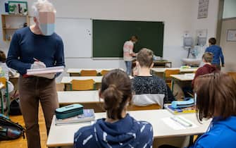 A teacher checks the results of student's rapid COVID-19 antigen self-tests in a primary school in Kranj.
Starting on Wednesday, primary and secondary school children in Slovenia are required to self-test in school three times a week as the country faces a severe outbreak of COVID-19.