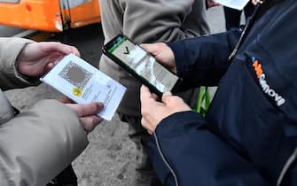 Italian Police and staf of AMT check the QR code confirming that people received the Covid-19 vaccine, at Brignole bus stop in Genoa, Italy, 06 December 2021. The measures on the 'enhanced' green certificate (obtainable only with vaccination or recovery) come into effect from 06 December 2021 until 15 January 2022ANSA/LUCA ZENNARO