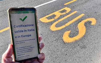 A valid Green Pass for Italy and EU is diplayed on a smartphone while Italian Police and staff of AMT check the QR code confirming that people received the Covid-19 vaccine, at the Brignole bus stop in Genoa, Italy, 06 December 2021. The measures on the 'enhanced' green certificate (obtainable only with vaccination or recovery) come into effect from 06 December 2021 until 15 January 2022. EPA-ANSA/LUCA ZENNARO