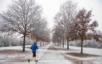 A snow covered street after the first snow that fell abundantly in some parks in Milan, Italy, 08 December 2021.  ANSA/Andrea Fasani