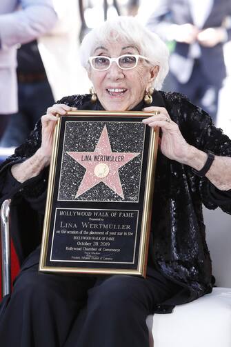 epaselect epa07957117 Italian filmmaker Lina Wertmuller reacts during her Hollywood Walk of Fame star ceremony in Hollywood, Los Angeles, California, USA 28 October 2019. Lina Wetmuller received the 2,679th star on the Hollywood Walk of Fame in the category of Motion Pictures.  EPA/NINA PROMMER