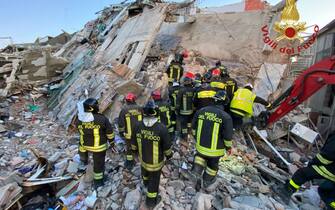 epa09639814 A handout photo made available by Vigili del Fuoco shows rescue teams at the scene of a blast caused by a gas leak in Ravanusa, Sicily, Italy, 13 December 2021. Firefighters found a fourth body in the rubble of the collapsed buildings in Ravanusa which is believed to be a woman. Previously, the bodies of two women and a man were recovered; two survivors were rescued and five people are still missing.  EPA/US VIGILI DEL FUOCO HANDOUT BEST QUALITY AVAILABLE HANDOUT EDITORIAL USE ONLY/NO SALES