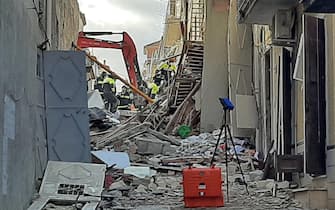 Rescue teams use an excavator at the scene of a blast caused by a gas leak in Ravanusa, Sicily, Italy, 12 December 2021. Firefighters found a fourth body in the rubble of the collapsed buildings in Ravanusa which is believed to be a woman. Previously, the bodies of two women and a man were recovered; two survivors were rescued and five people are still missing. ANSA/ Matteo Guidelli