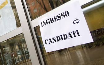 Un cartello che indica l'ingresso per i candidati a un concorso
