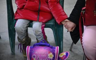 VOLPIANO, ITALY - MARCH 07: Two Ukrainian refugees hold hands as they arrive by bus after a long trip from Poland on March 7, 2022 in Volpiano near Turin, Italy.  A bus of volunteers made available by Specchio dei Tempi and Arca Solidale, two solidarity associations, left on March 5 loaded with basic necessities and arrived in the Polish town of Jaroslaw, on the border with Ukraine. There 60 Ukrainian refugees awaited evacuation to Turin in Italy on the evening of March 7. Russia began its invasion of Ukraine on February 24. (Photo by Stefano Guidi/Getty Images)