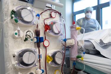 25 March 2022, Lower Saxony, Osnabrück: A nurse stands at the bedside of an intensive care patient behind a dialysis machine. Patients with severe corona are cared for in the intensive care unit. Many patients with severe courses of the disease spend several weeks in the intensive care unit, and around half of the artificially ventilated patients die. Photo: Friso Gentsch/dpa (Photo by Friso Gentsch/picture alliance via Getty Images)