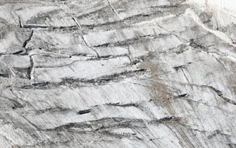 An aerial view taken from a helicopter of the glacier that collapsed triggering an avalanche on the Marmolada Mountain in Canazei, Italy, 05 July 2022. At least seven people were killed and dozens were still missing on 04 July, a day after the avalanche hit the multi-peak mountain of the Italian Dolomites.    ANSA/ANDREA SOLERO