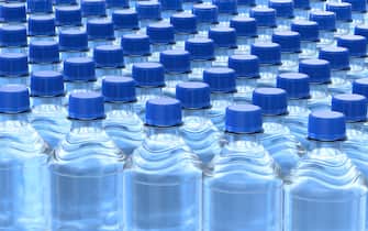 Rows of plastic bottles of clear purified drink carbonated water with blue caps. 3D illustration