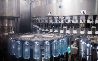 Plastic water bottles are prepared to be filled at the Ice River Springs Water Co. bottling facility in Chilliwack, British Columbia, Canada, on Monday, Nov. 18, 2019. Ice River Springs utilizes a closed-loop recycling process and is the only beverage company in North America operating their own recycling facility. Photographer: James MacDonald/Bloomberg