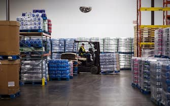 A worker drives a forklift carrying a pallet of plastic water bottles through the Ice River Springs Water Co. bottling facility in Chilliwack, British Columbia, Canada, on Monday, Nov. 18, 2019. Ice River Springs utilizes a closed-loop recycling process and is the only beverage company in North America operating their own recycling facility. Photographer: James MacDonald/Bloomberg