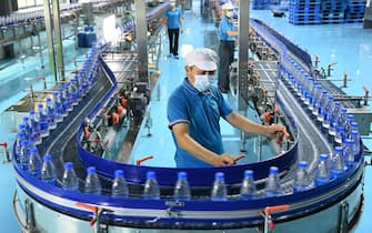 YICHUN, CHINA - JULY 04: Employees work on the production line of bottled water at a factory on July 4, 2022 in Yichun, Jiangxi Province of China. (Photo by Deng Longhua/VCG via Getty Images)