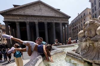 ROME, ITALY, AUGUST 10:
A man plays with a child at a fountain in front of the Pantheon during a sunny day in Rome, Italy, on August 10, 2022. Except a few scattered thunderstorms, much of Italian peninsula is still facing a strong heatwave which is forecast to continue for the next few days. (Photo by Riccardo De Luca/Anadolu Agency via Getty Images)