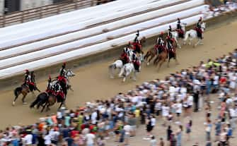 Italian Carabinieri police officers parade on horseback at Piazza del Campo, on the eve of the historical Italian horse race 'Palio di Siena' in Siena, Italy, 16 August 2022
ANSA/CLAUDIO GIOVANNINI