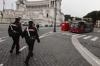 ROME, ITALY, DECEMBER 06: Carabinieri officers approach a bus to check passengers' Covid-19 green passes and documents in Rome, Italy, on December 06, 2021. Starting from December 6 customers of cafes and restaurants and participants of social events must have a so called super green pass, a reinforced certification which they can obtain either through vaccination or recovery from Covid, not via a negative test result, while passengers of public transportation are asked a normal green pass. (Photo by Riccardo De Luca/Anadolu Agency via Getty Images)