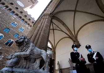 Italian Carabinieri police officers stand at the Loggia dei Lanzi building on Piazza della Signoria in Florence on June 2, 2020, on the eve of the reopening of the Uffizi Gallery Museum to the public, as the country eases its lockdown aimed at curbing the spread of the COVID-19 infection, caused by the novel coronavirus. (Photo by Tiziana FABI / AFP) (Photo by TIZIANA FABI/AFP via Getty Images)