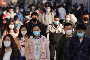 BEIJING, CHINA - APRIL 13:  Commuters wear protective masks as they exit a train at a subway station during Monday rush hour on April 13, 2020 in Beijing, China. According to the statistics of the World Health Organization, as of today, the cumulative number of confirmed cases of COVID-19 has exceeded 1.69 million, including 106,138 deaths.  (Photo by Lintao Zhang/Getty Images)