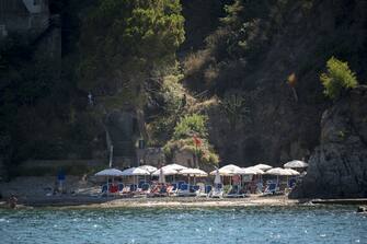 CEFALU, ITALY - JULY 10: A small beach in a "caletta" (cove) during summer season as local and foreigner tourists start to gather in Cefalu, the old town in PalermoÃ¢s province (Sicily), included in the UNESCOÃ¢s heritage list for its Arab-Norman architecture, Italy on July 10, 2022. The wide coastline, with sandy and rocky beaches, also attracts tourists. (Photo by Valeria Ferraro/Anadolu Agency via Getty Images)