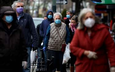 THE BRONX, NY - APRIL 10: A line of masked people wait to pick up food from Biancardis on Arthur Ave. in the Bronx, NY, on April 10, 2020. (Photo by Yana Paskova/For The Washington Post via Getty Images)