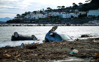 TOPSHOT - Damaged cars are seen on the beach of Casamicciola on November 27,2022, following heavy rains that caused a landslide on the island of Ischia, southern Italy. - Italian rescuers were searching for a dozen missing people on the southern island of Ischia after a landslide killed at least one person, as the government scheduled an emergency meeting. A wave of mud and debris swept through the small town of Casamicciola Terme early Saturday morning, engulfing at least one house and sweeping cars down to the sea, local media and emergency services said. (Photo by Eliano IMPERATO / AFP) (Photo by ELIANO IMPERATO/AFP via Getty Images)