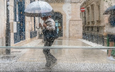 People Walking In The Street During Heavy Rain, Ortigia, Syracuse (Siracusa), Sicily, Italy
